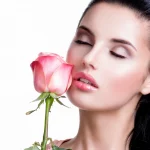 closeup-portrait-sensual-beautiful-woman-with-pink-rose-white-wall_186202-9017