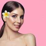 attractive-spa-woman-with-perfect-healthy-skin-tropic-flower-pink-background-facial-treatment-cosmetology-spa_221436-4087