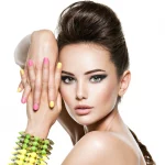 beautiful-woman-with-multicolored-nails-studded-bracelet-hand_186202-6208